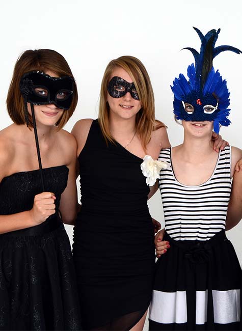 Three females wearing masks for their summer prom event