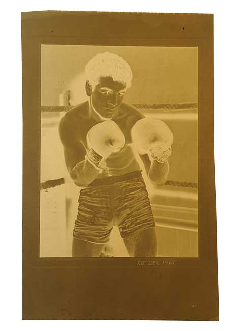 Old negative of a boxer posing in the ring