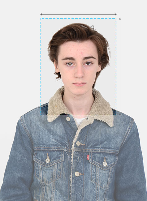 A male poses for a passport photo. Highlighted in the image is the man's head, with annotations showing the correct width, height and framing of an approved passport photo.